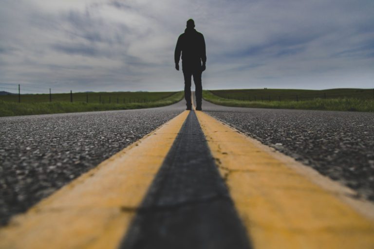 man walking down road to nowhere