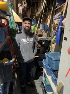 picture of routesetter Todd Stebbing behind the rock climbing wall